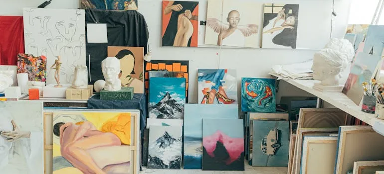 Art studio with various paintings, sculptures, and art supplies